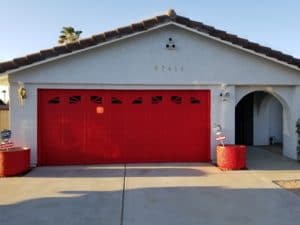 Stucco house with red garage door